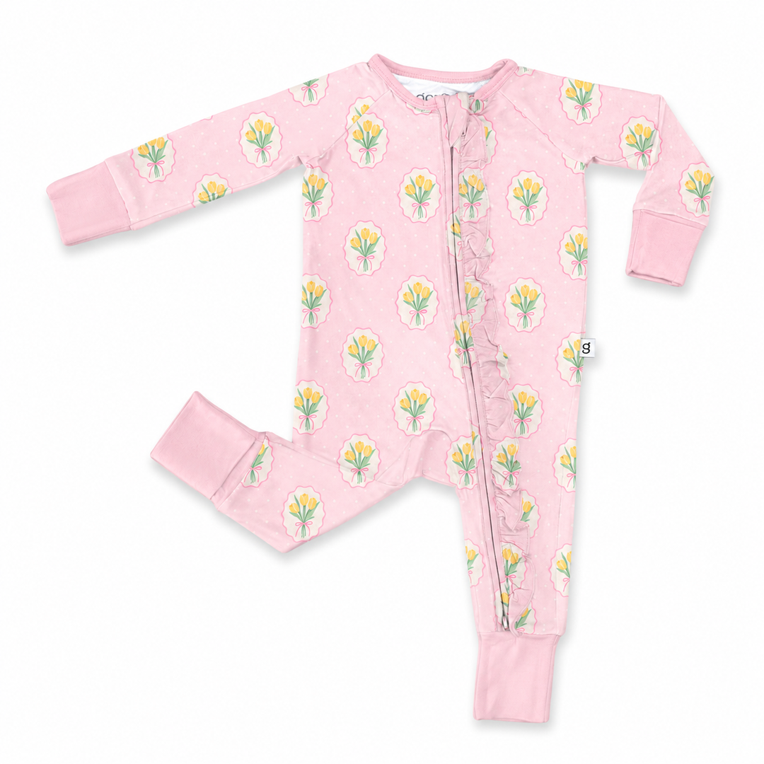 Pink baby onesie with floral pattern on a white background