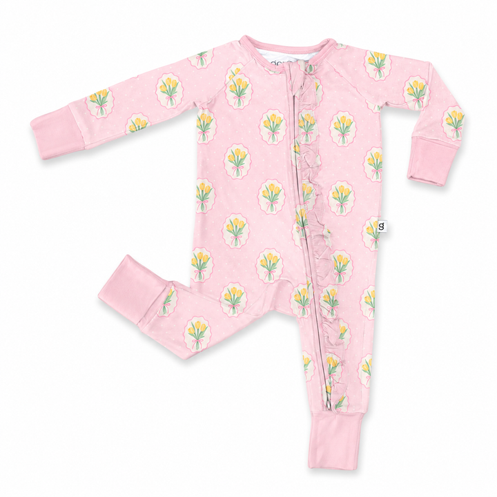 Pink baby onesie with floral pattern on a white background