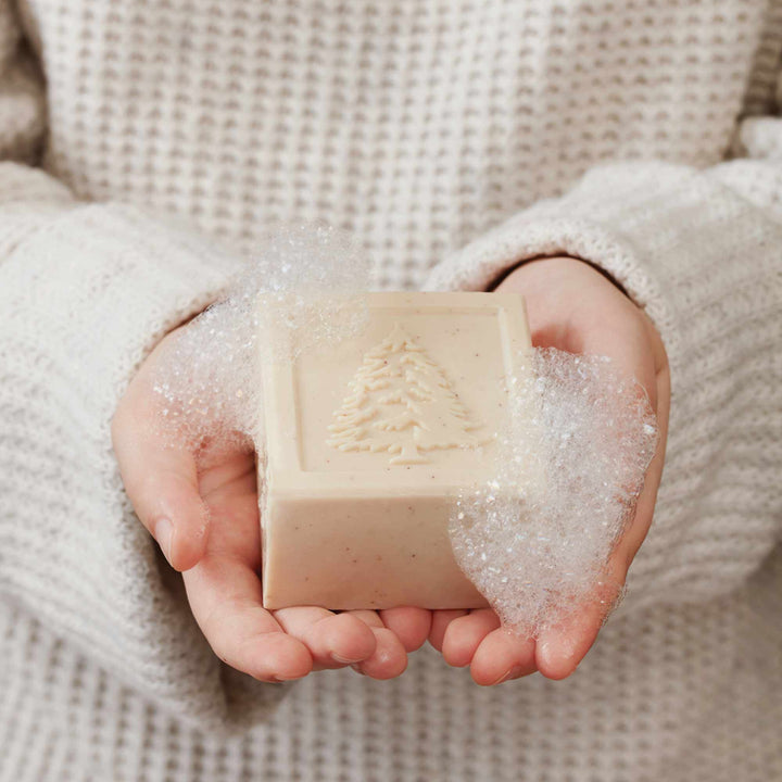 Frasier Fir bar soap held in foamy hands