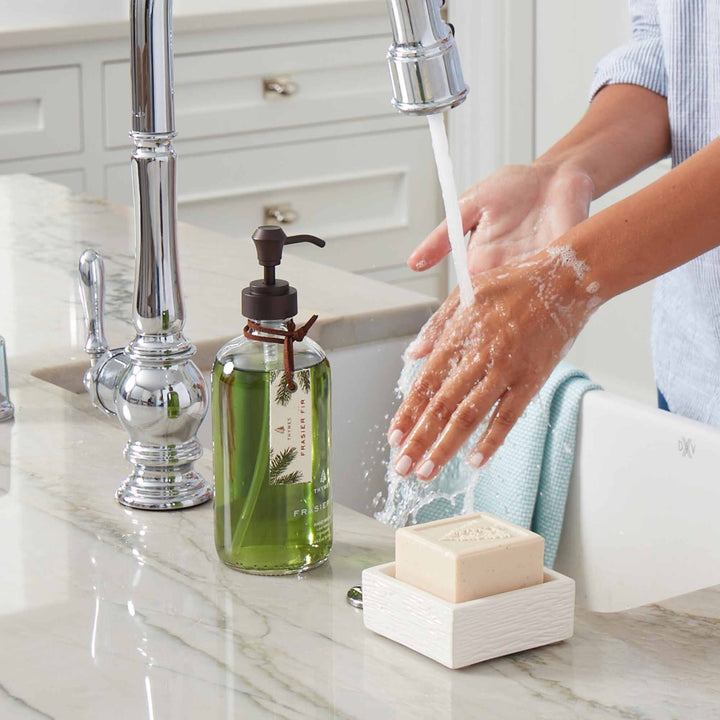 Hands washing with Frasier Fir bar soap at a sink