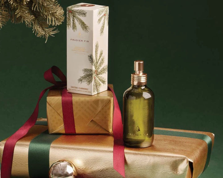 Frasier Fir holiday fragrance collection arranged with an evergreen wreath