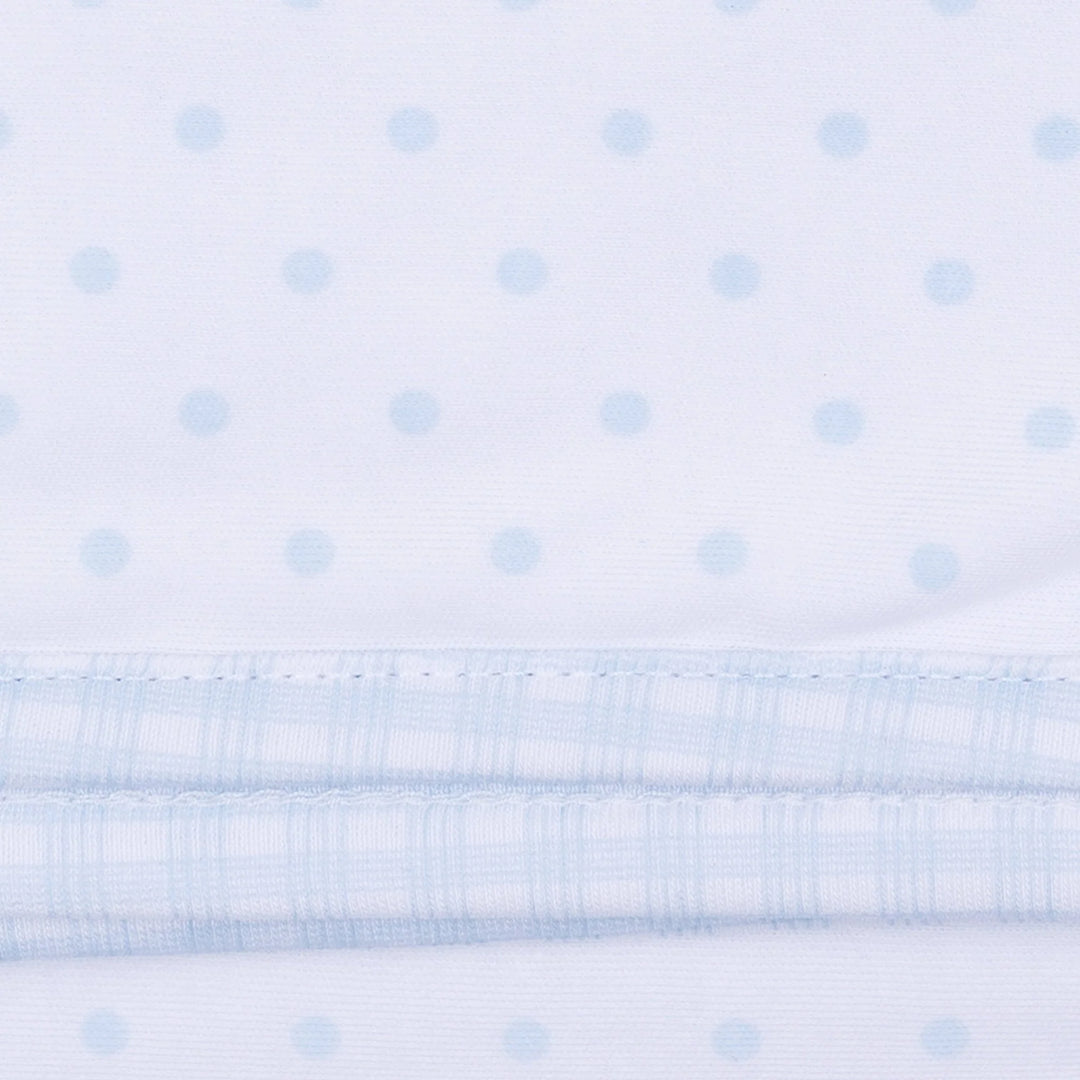 White fabric with a subtle light blue dot pattern and a gingham light blue trim.
