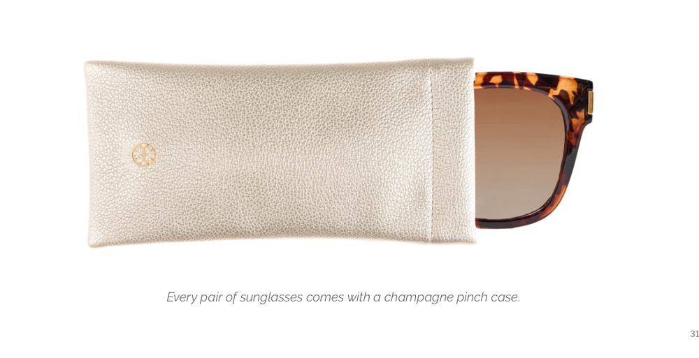 A pair of sunglasses partially pulled from a champagne-colored textured leather case on a white background, with small text below stating, 'Every pair of sunglasses comes with a champagne pinch case.'.