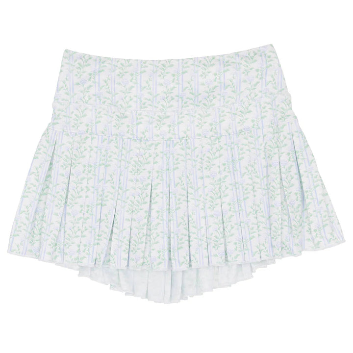 White pleated skirt with green floral pattern on a white background