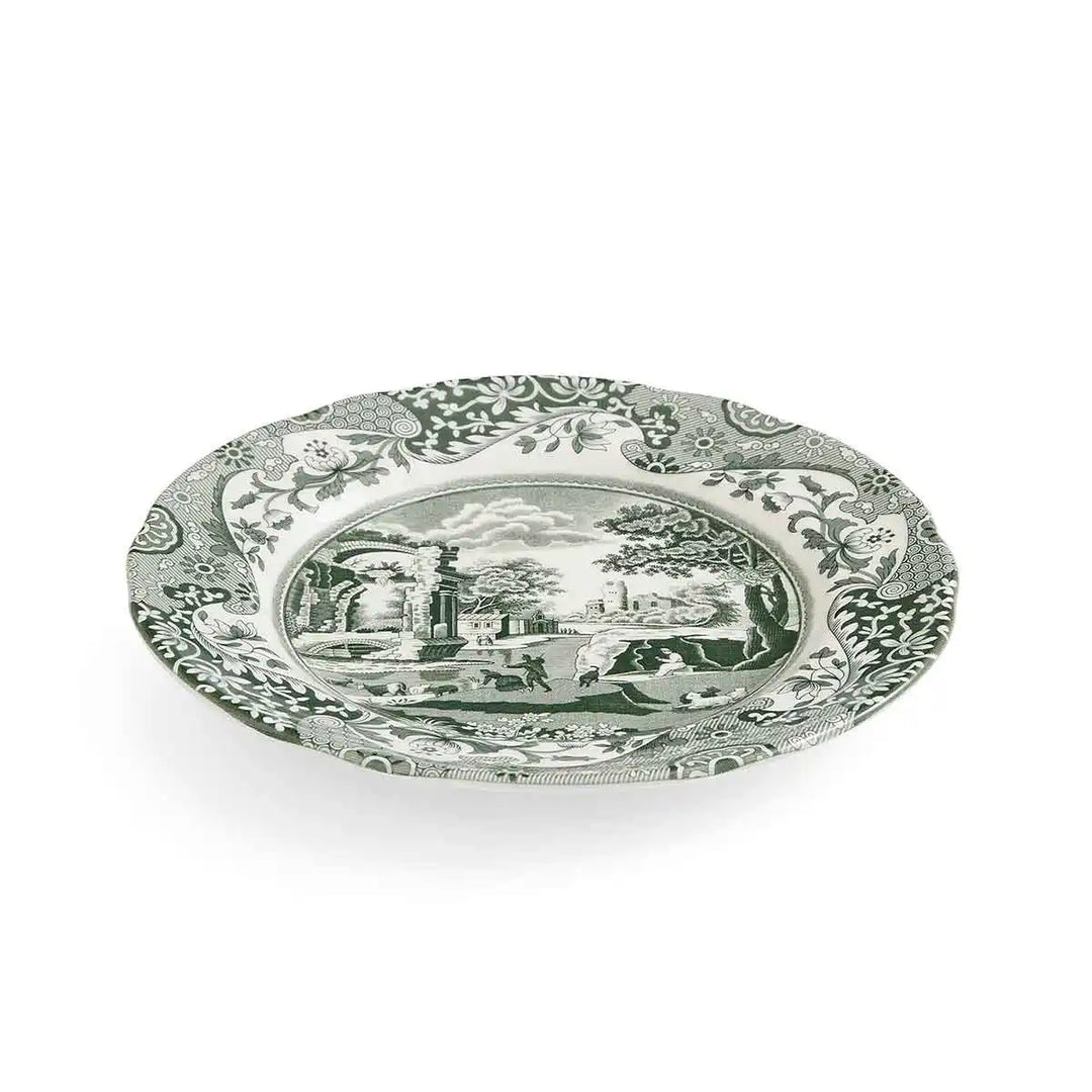 Decorative plate with intricate design and central scene on a white background