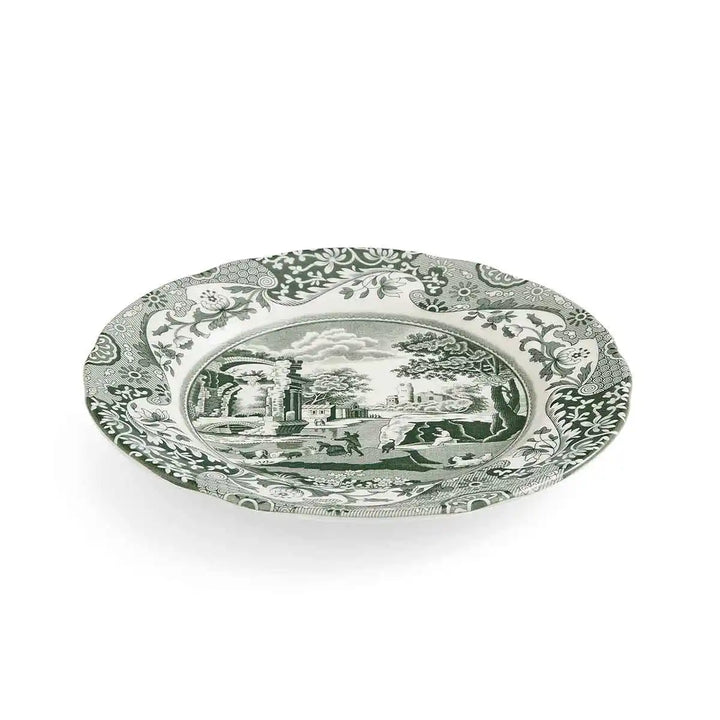 Decorative plate with intricate design and central scene on a white background