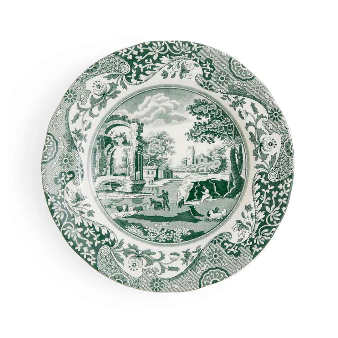 Decorative plate with green scenic design and floral border on a white background