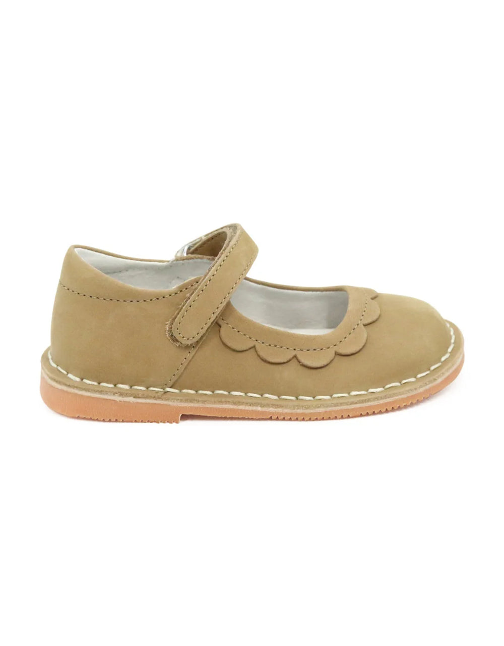 Beige children's shoe with a scalloped edge on a white background