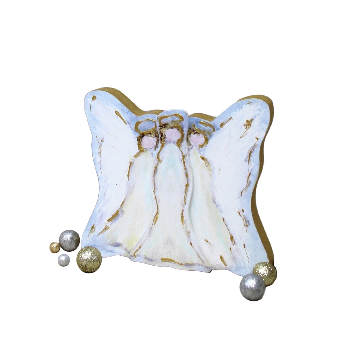 Decorative angel figurine with marbled design on a wooden surface with small balls around.