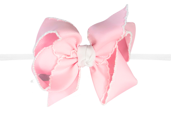 Pink hair bow on a white background