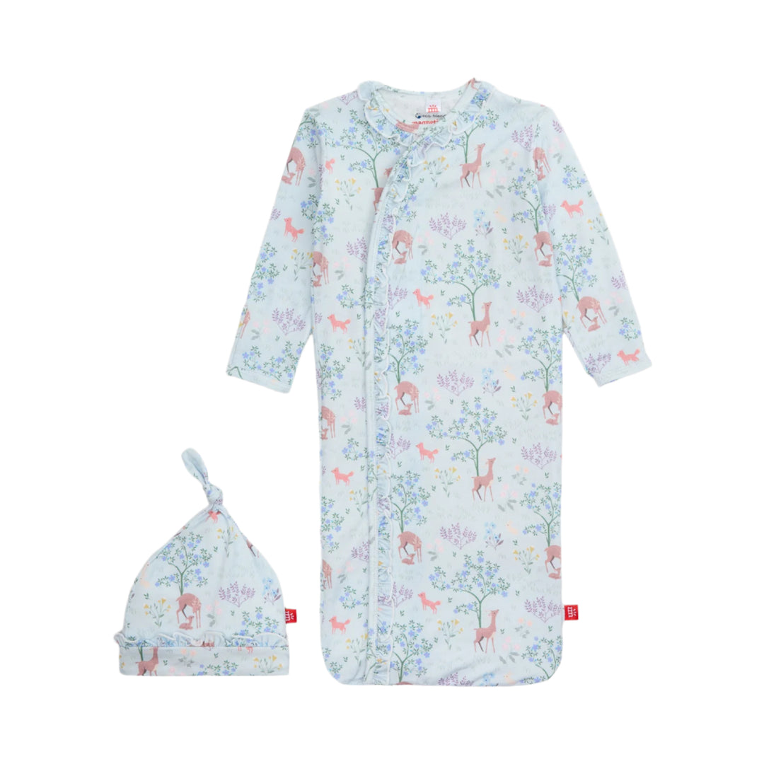 Baby gown with floral and animal pattern and matching hat on a white background