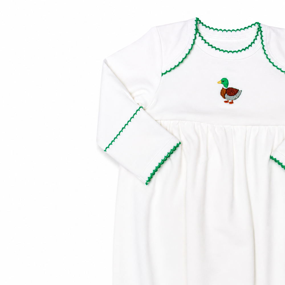 White long-sleeve shirt with green trim and a duck design on a white background