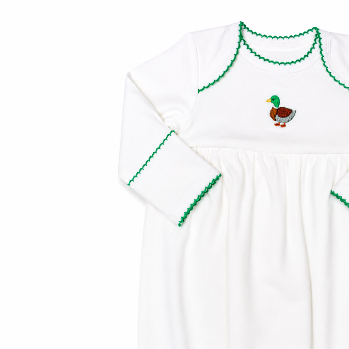 White long-sleeve shirt with green trim and a duck design on a white background