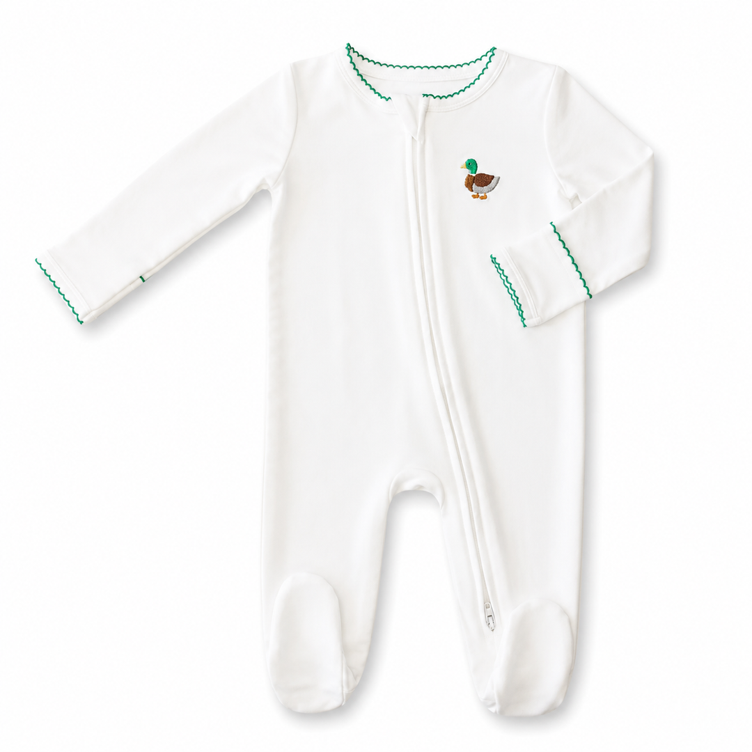White baby footie with green trim and a small mallard motif on a white background