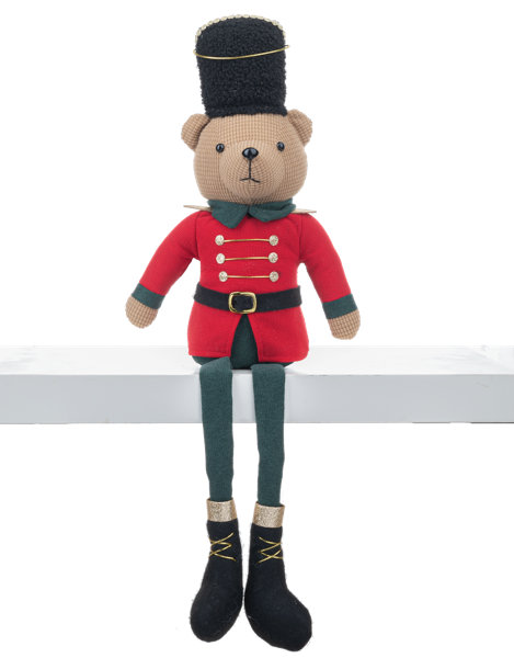 Stuffed toy bear in a military uniform sitting on a white surface