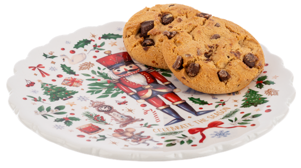 Chocolate chip cookie on a decorative Christmas plate with a nutcracker design.