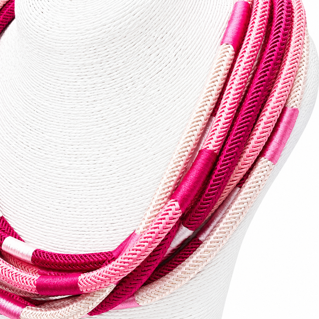Close-up of pink and white braided cable on a white background