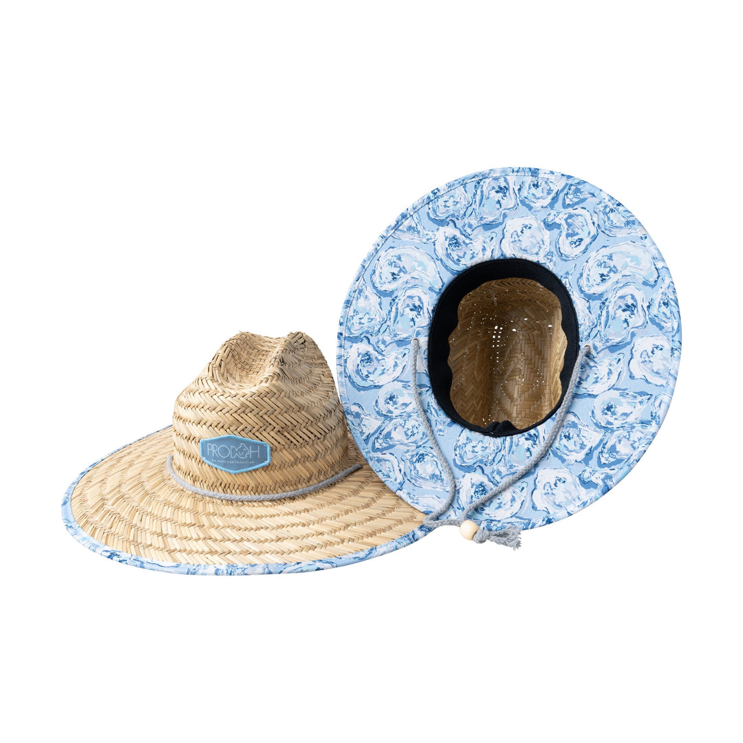Two hats, one straw and one patterned, on a white background