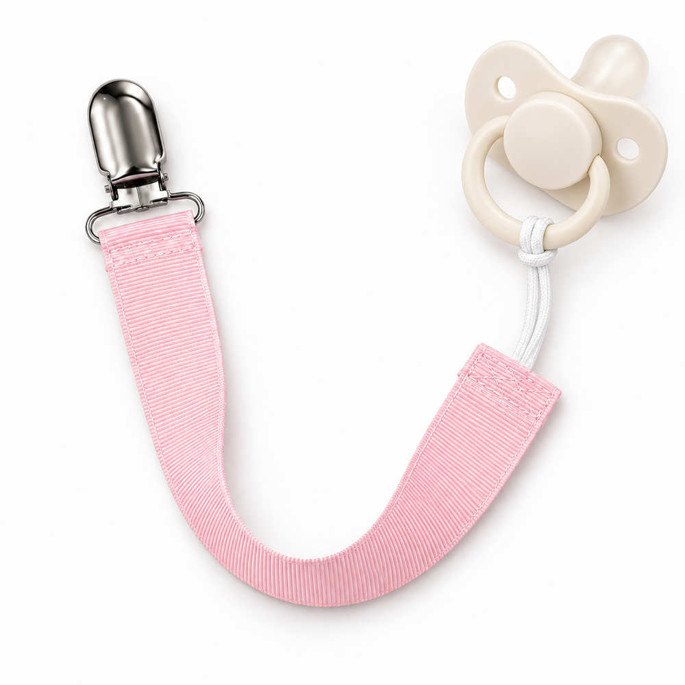 light pink paci clip showing how it holds a paci