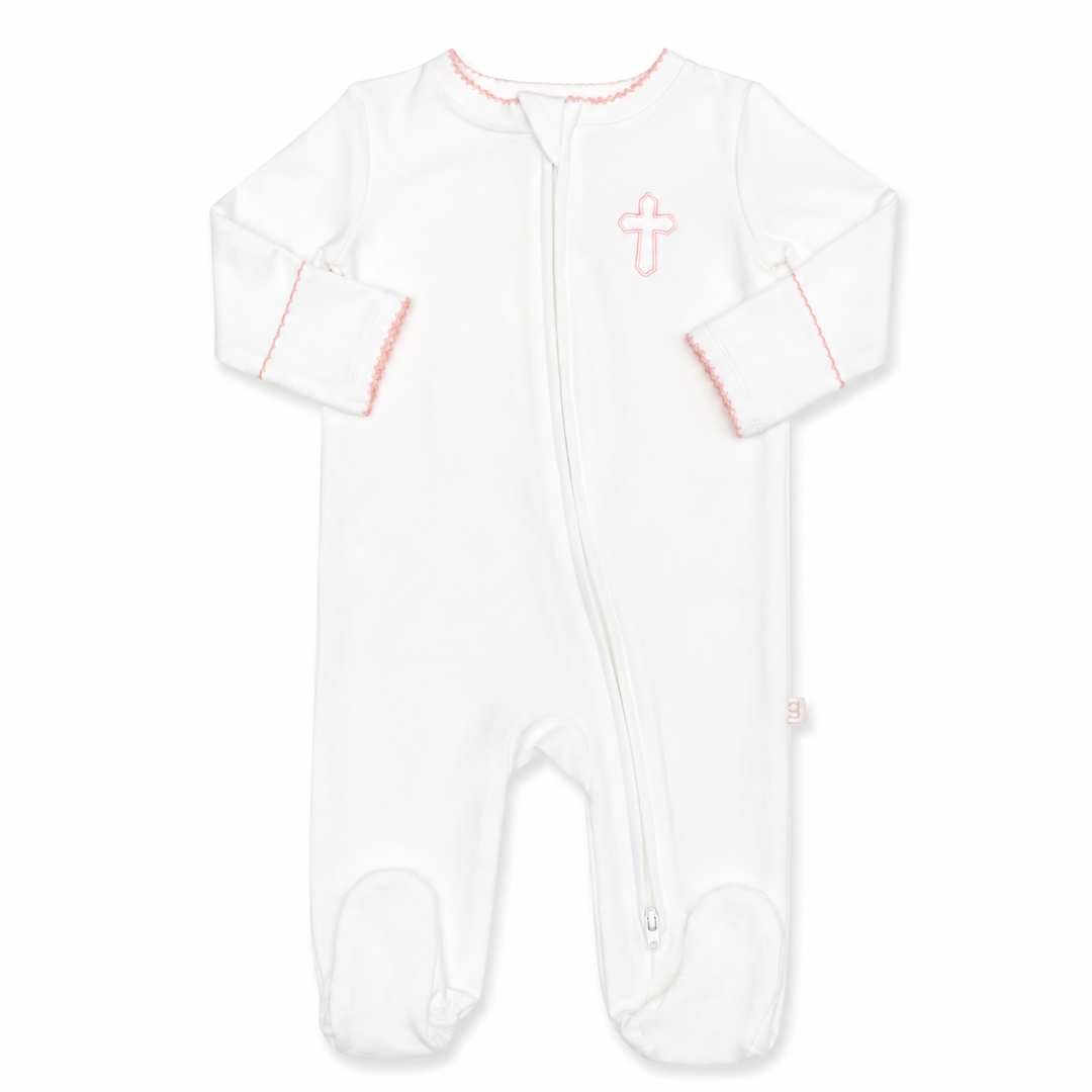 White baby onesie with pink accents and a cross design on a white background