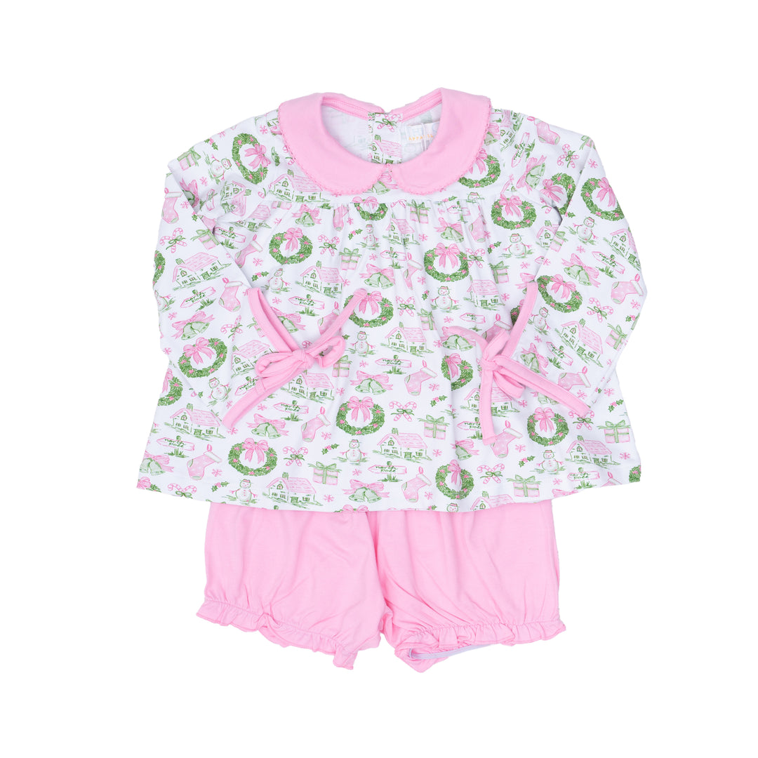Baby outfit with floral patterned top and pink shorts on a white background