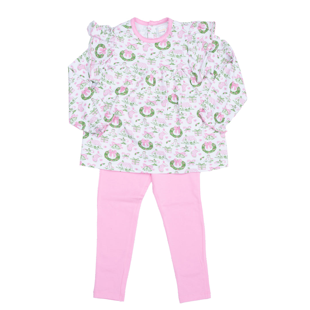 Children's outfit with floral top and pink pants on a white background