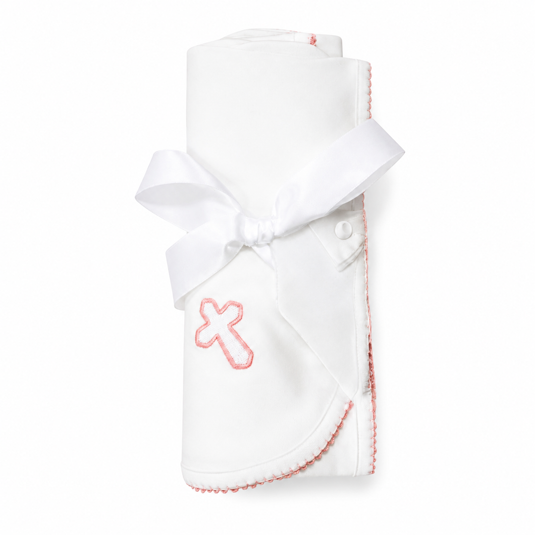White baby blanket with pink cross design on a white background