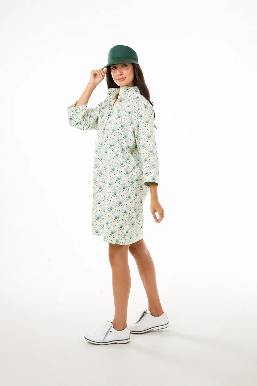 women's long sleeve mini dress with green fan like design on beige background