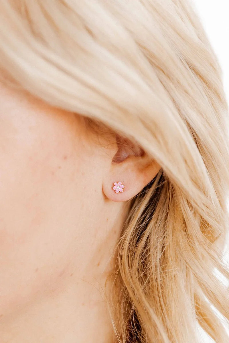 Alli pink flower screwback stud earring worn on the ear for a delicate everyday look