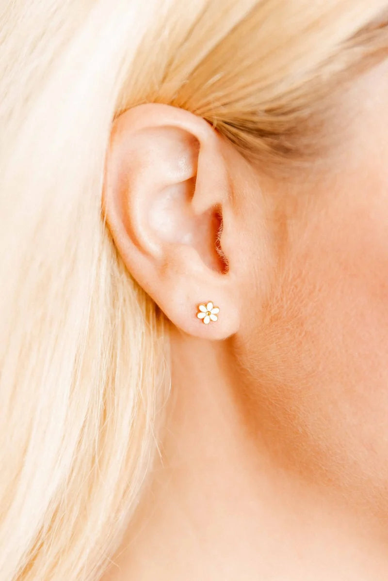 Alli white flower screwback stud earring worn on the ear for a classic everyday look
