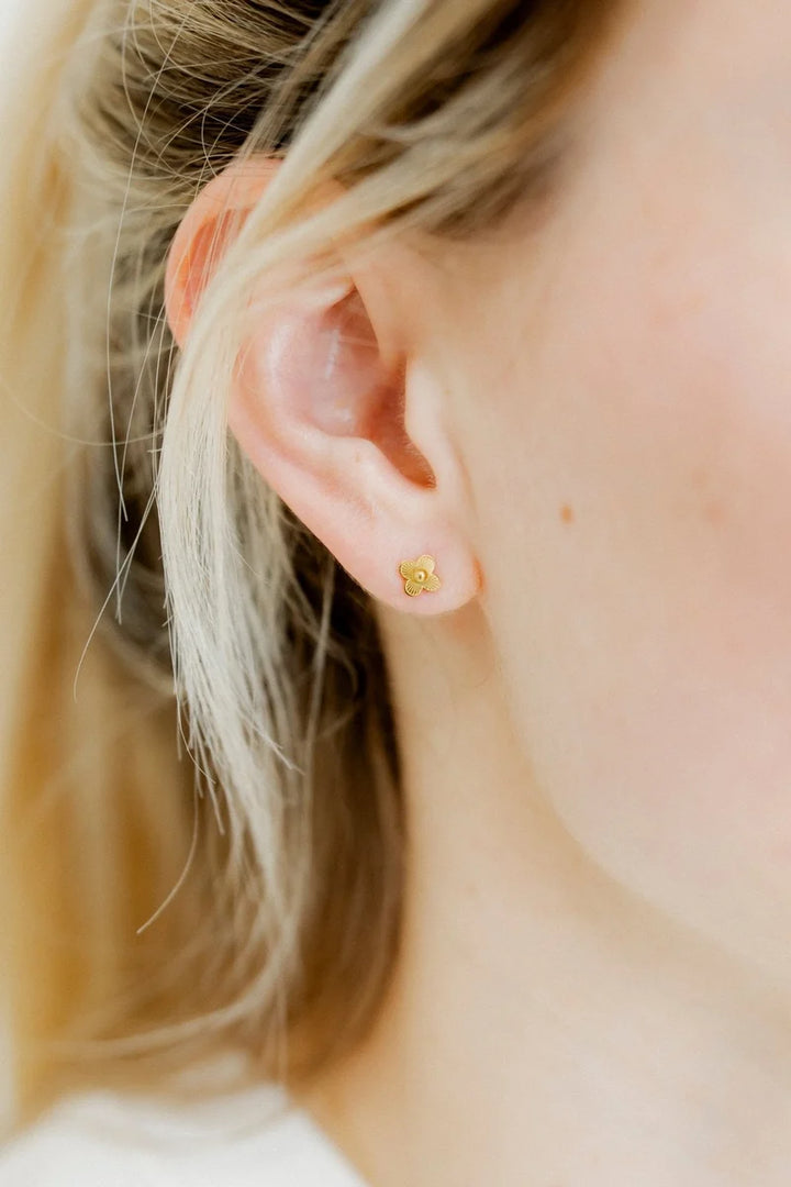 Sweet Clover gold screwback stud earring worn on the ear for a polished everyday accent
