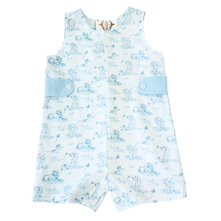 A shortall for a baby boy with a puppy pattern and blue trim.