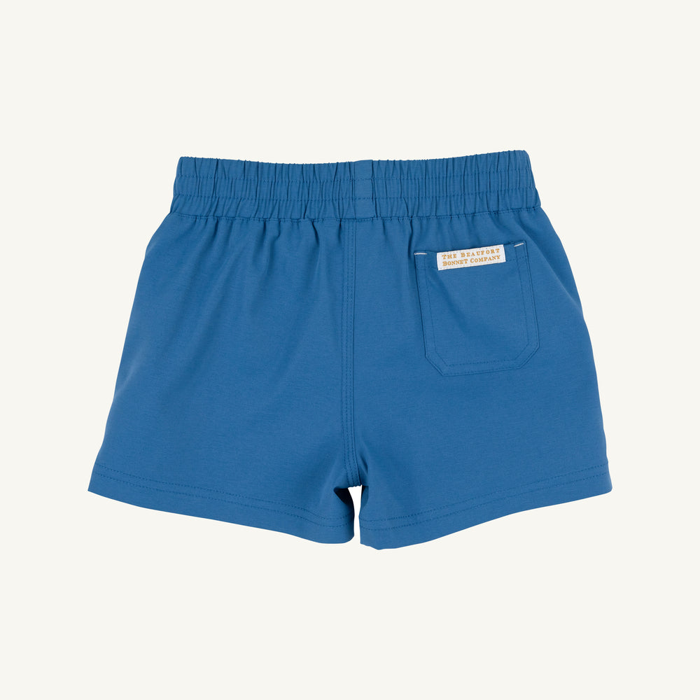 Blue shorts with a brand label on a white background