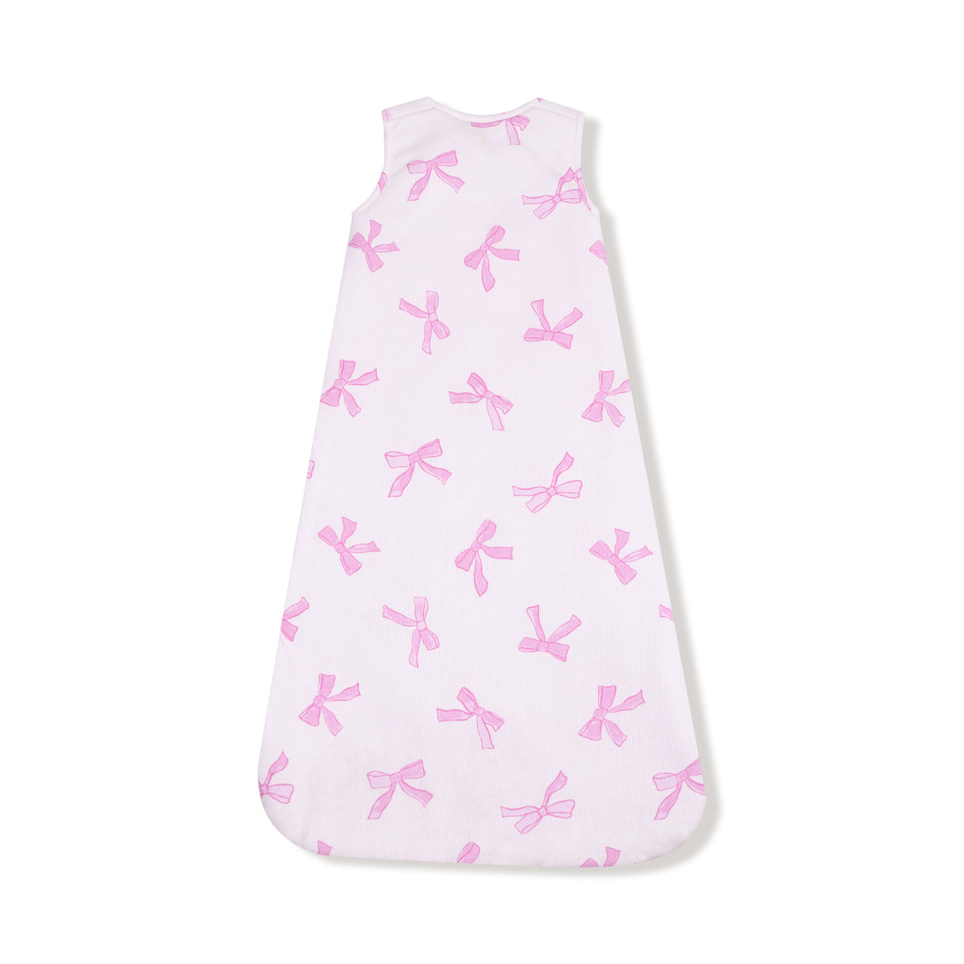 Baby sleeping bag with pink bow pattern on a white background