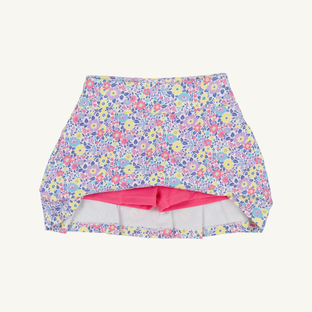 Floral-patterned swim skirt with pink lining on a white background