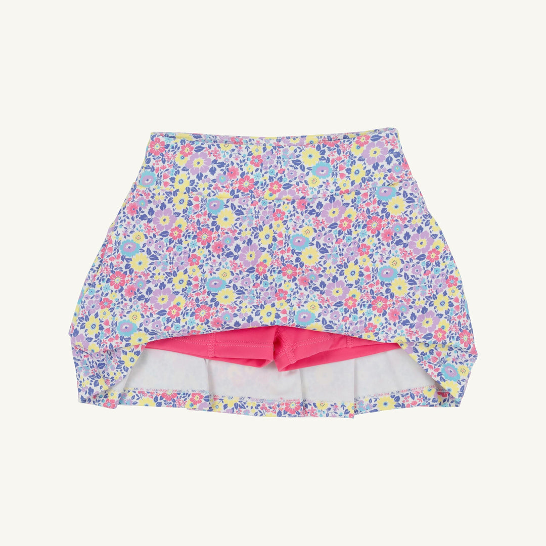 Floral-patterned swim skirt with pink lining on a white background