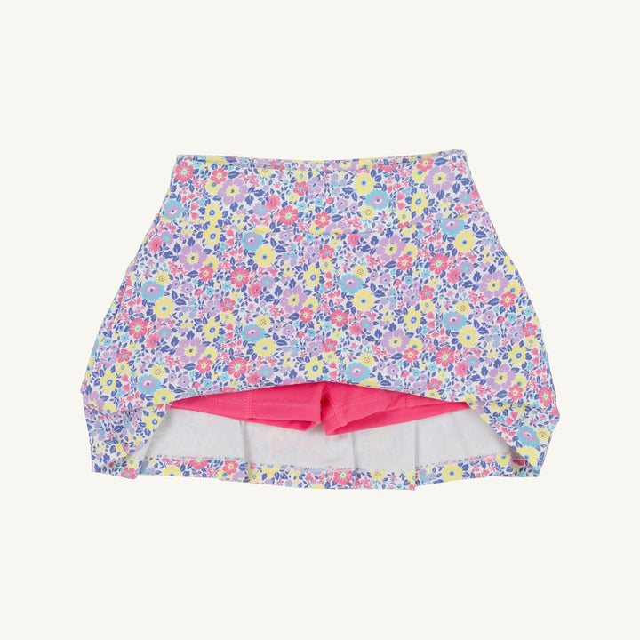 Floral-patterned swim skirt with pink lining on a white background