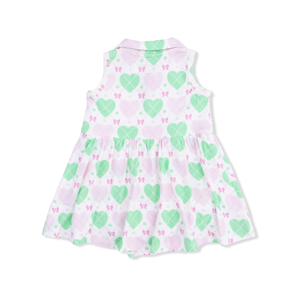 Children's sleeveless dress with green heart and pink bow pattern on a white background