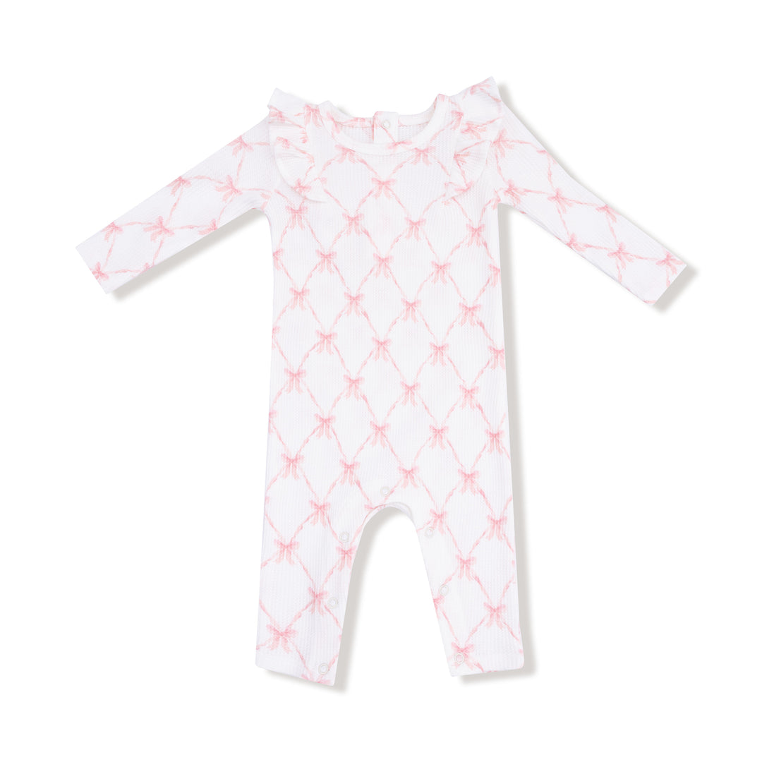 White baby onesie with pink geometric pattern on a white background
