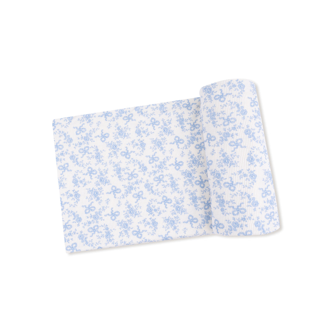Floral-patterned fabric roll on a white background