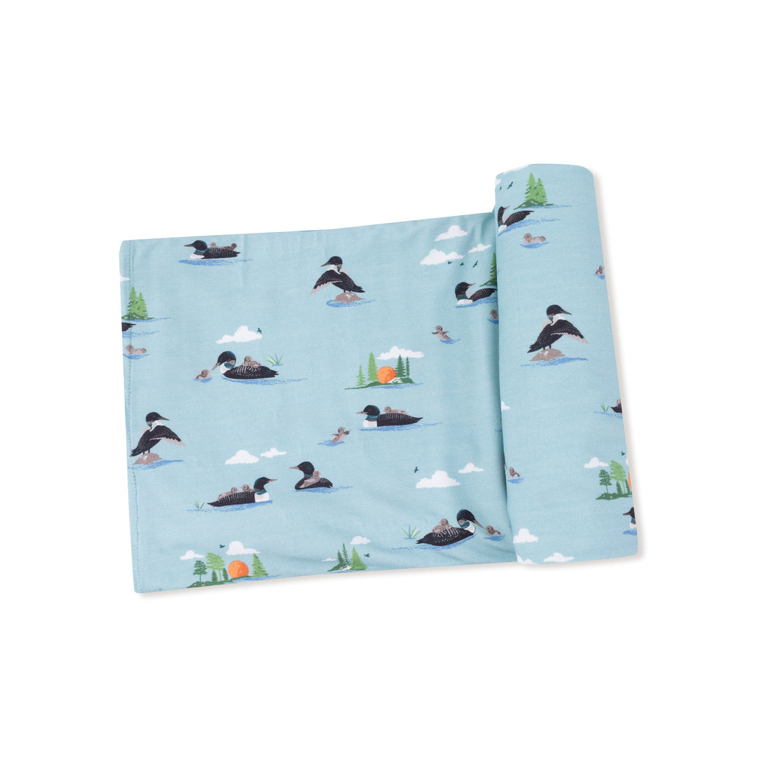 Roll of paper towel with duck design on a light blue background