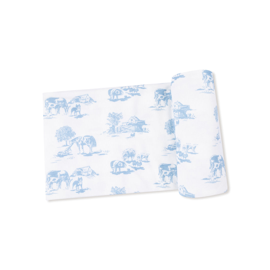 White blanket with blue animal pattern on a white background