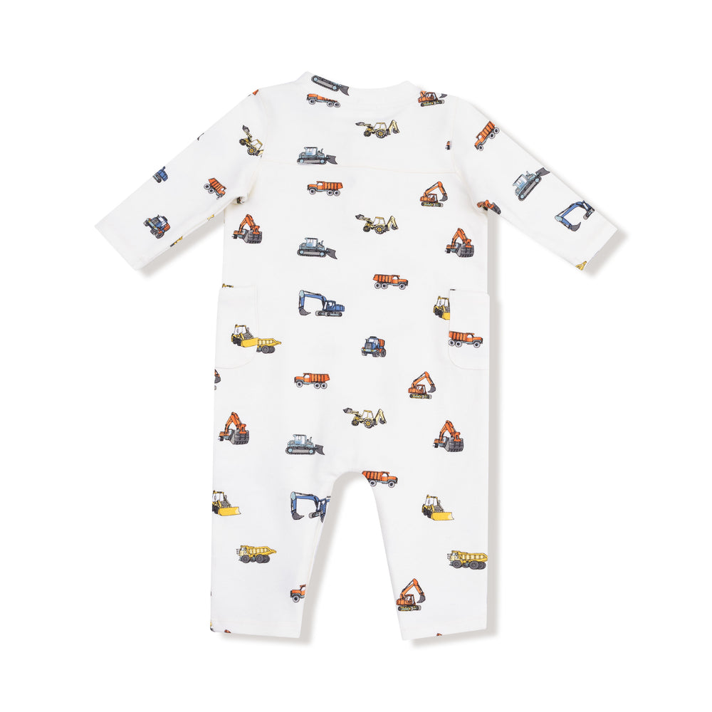White baby onesie with construction vehicle pattern on a white background