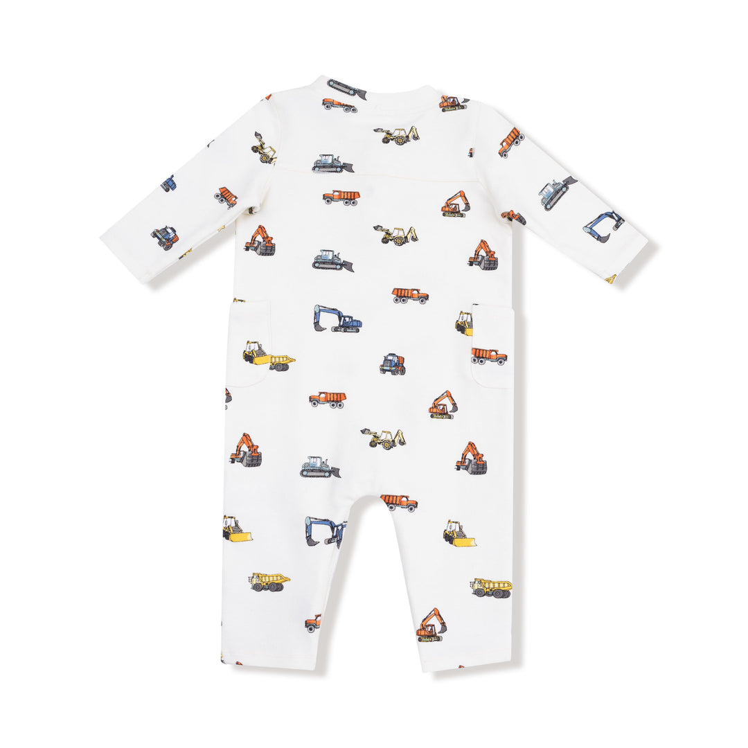 White baby onesie with construction vehicle pattern on a white background