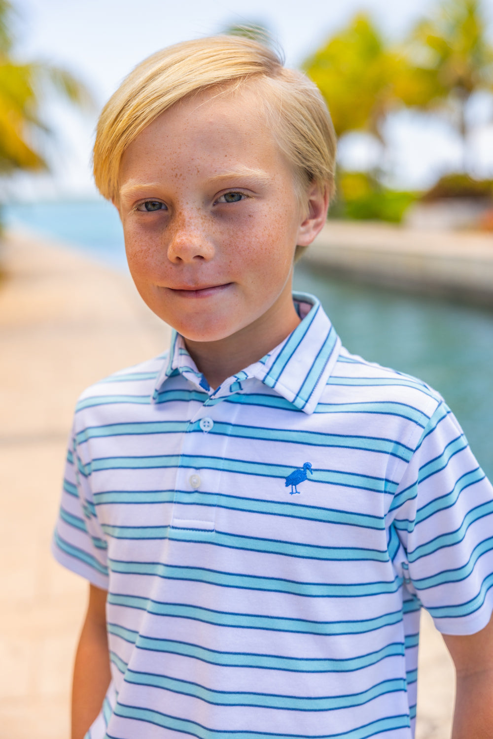 BLUE AND NAVY STRIPE SHORT SLEEVE POLO ON LITTLE BOY