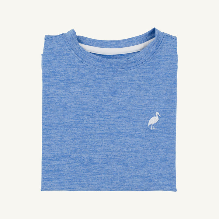 Folded blue t-shirt with a small white logo on a light gray background