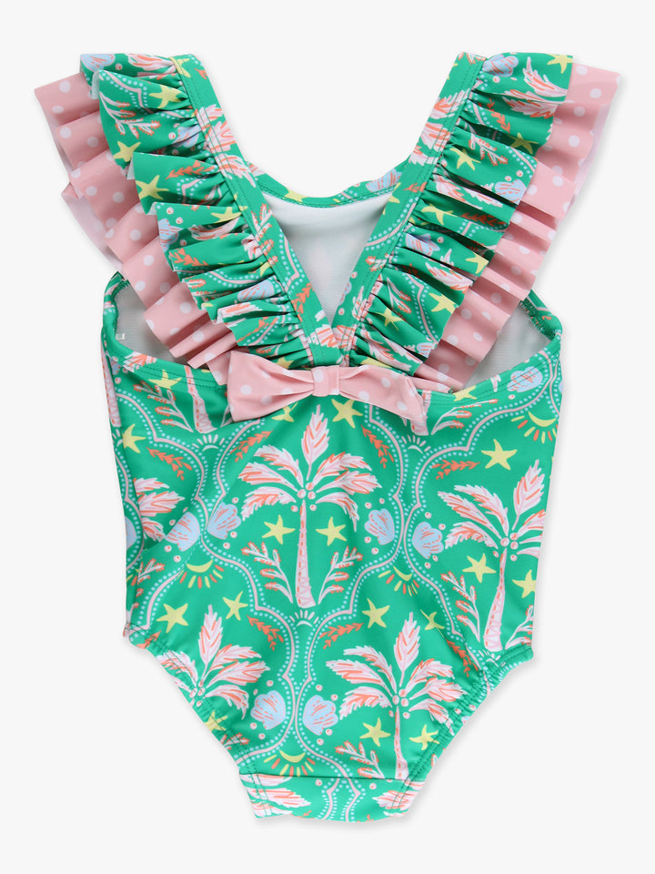 Green and pink patterned swimsuit with ruffled details on a white background