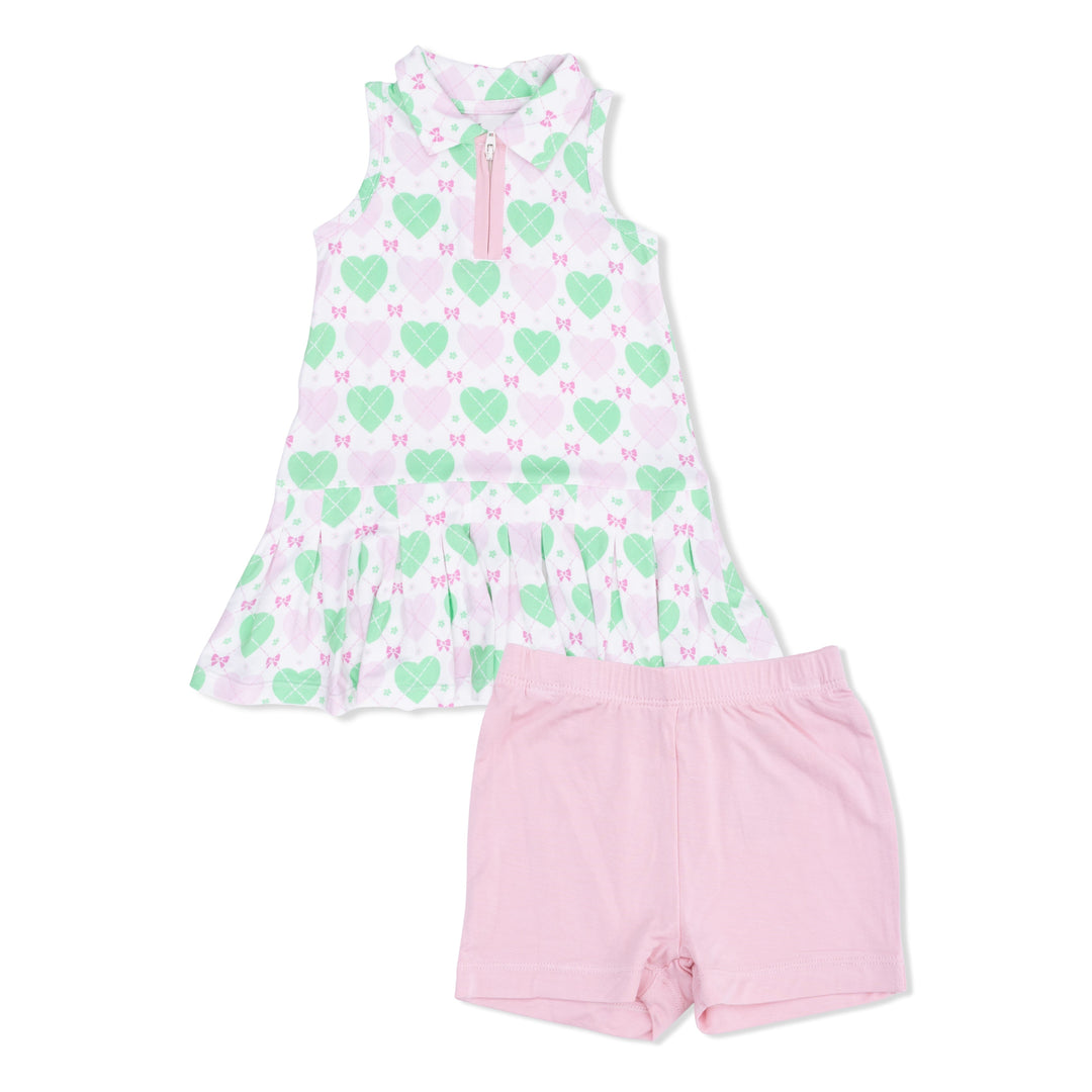 Children's dress with green heart pattern and pink shorts on a white background