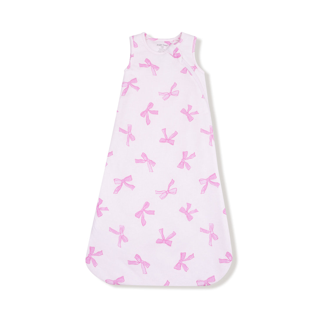 Baby sleeping bag with pink bows on a white background