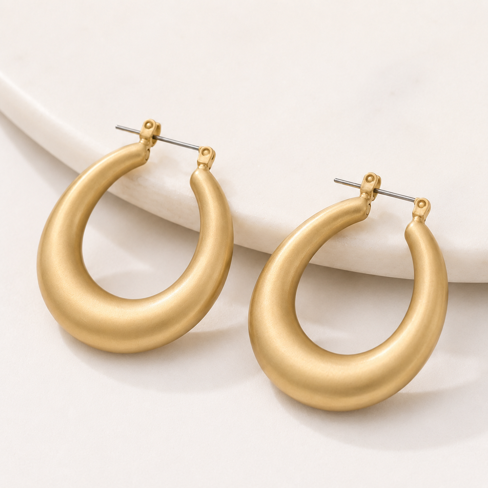 Gold hoop earrings on a white background